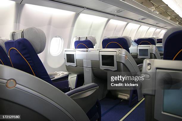 business class airliner seat with multimedia monitor - first class flight stock pictures, royalty-free photos & images