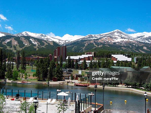 lush summer resort facing snowy mountains in the distance - breckenridge-summer stock pictures, royalty-free photos & images