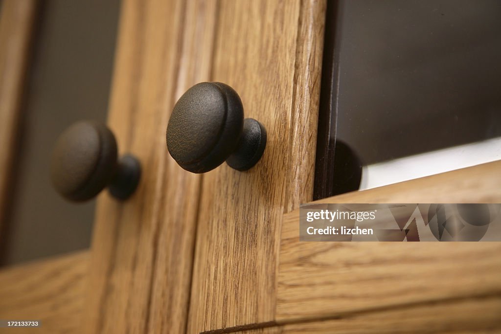 Close-up of a kitchen cabinet door knob in wood