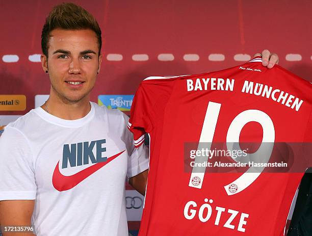 Mario Goetze of FC Bayern Muenchen presents his new match jersey after a press conference at Bayern Muenchens headquarter Saebener Strasse on July 2,...