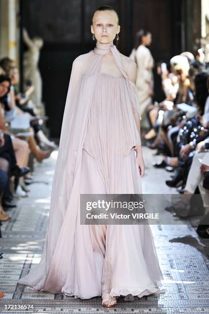 Model walks the runway during the Christophe Josse show as part of Paris Fashion Week Haute-Couture Fall/Winter 2013-2014 at les Beaux Arts on July...