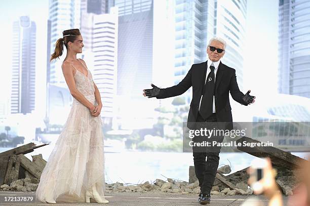 Fashion designer Karl Lagerfeld acknowledges applause following the Chanel show as part of Paris Fashion Week Haute-Couture Fall/Winter 2013-2014 at...