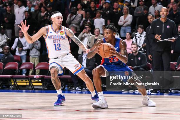 Marcus Sasser of the Detroit Pistons dribbles the ball against Lindy Waters III of the Oklahoma City Thunder during the second half of a preseason...