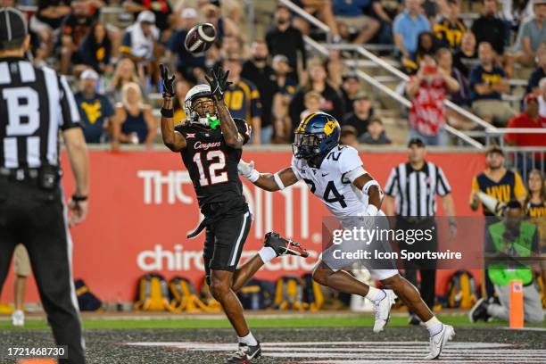 Houston Cougars wide receiver Stephon Johnson hauls in a late second half touchdown reception as West Virginia Mountaineers safety Marcis Floyd...