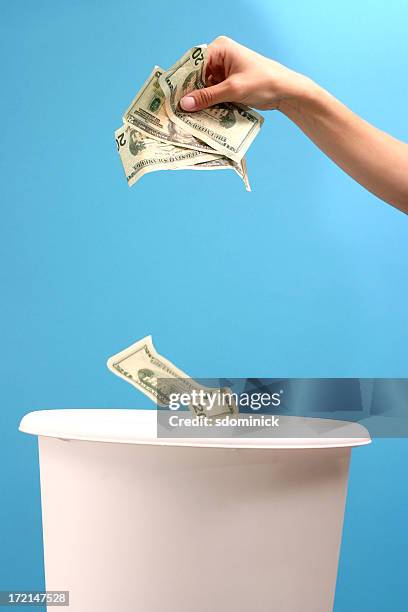 throwing money away - waste wealth stock pictures, royalty-free photos & images