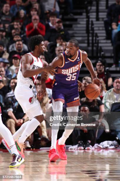 Kevin Durant of the Phoenix Suns handles the ball against defender Scoot Henderson of the Portland Trail Blazers during the preseason game on October...