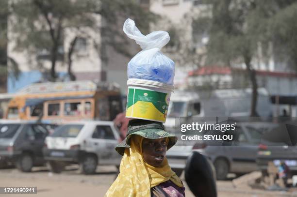 Vendor sells plastic sachets filled with drinkable water in Dakar, on August 25, 2023. Drinakble water sachets are integral to everyday life in...