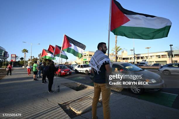 People demonstrate calling for peace and the end to the Israeli occupation of Palestine, in Los Angeles, California on October 12 after the...