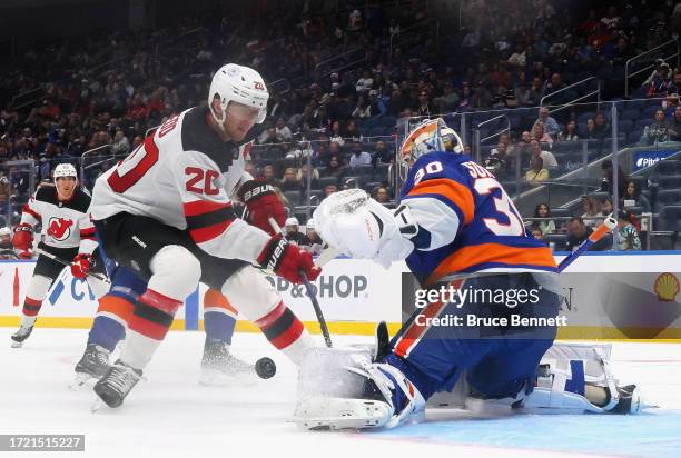 Ilya Sorokin of New York Islanders makes the second period save against Michael McLeod of New Jersey Devils at UBS Arena on October 06, 2023 in...