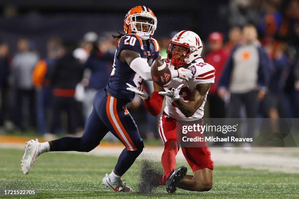 Marcus Washington of the Nebraska Cornhuskers catches a pass against Tyler Strain of the Illinois Fighting Illini during the first half at Memorial...