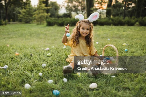Multi-ethnic girl searching for Easter eggs.