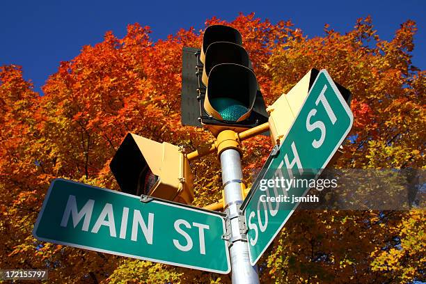 main street im herbst - ampel grün stock-fotos und bilder