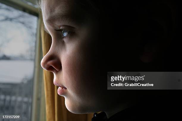 At A Window Boy Stares Sadly Outside High-Res Stock Photo - Getty Images