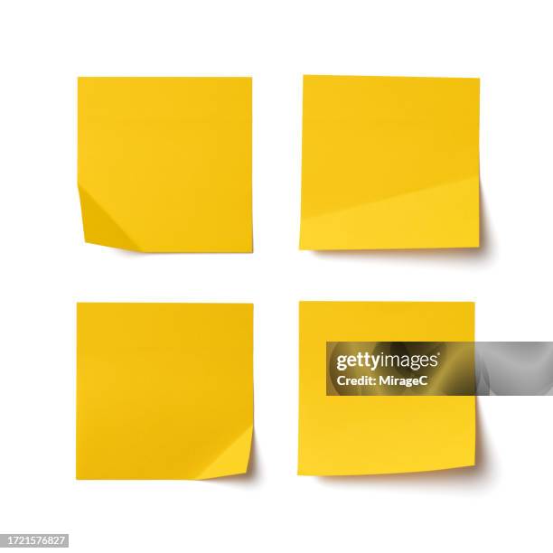 blank yellow adhesive notes with one corner folded isolated on white - biglietto adesivo foto e immagini stock