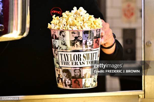 Tub of popcorn in US singer Taylor Swift's merchandise is pictured during the "Taylor Swift: The Eras Tour" concert movie world premiere at AMC...