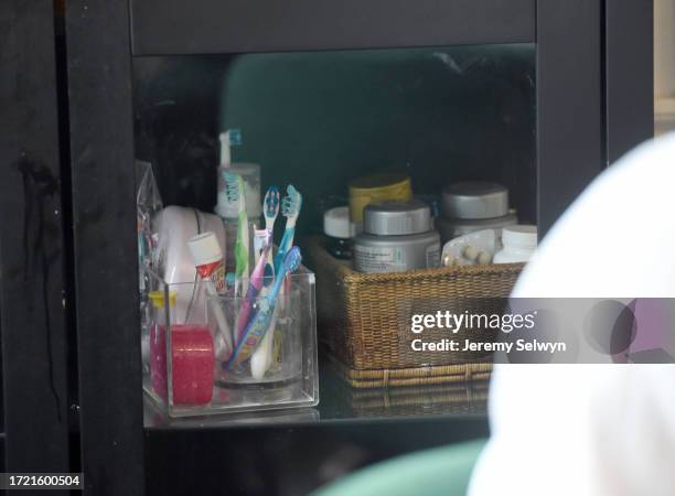 David Cameron In The Downing Street Kitchen..Toothbrushes Inside A Kitchen Cupboard Behind Mr Cameron..David Cameron In His Kitchen In Downing...