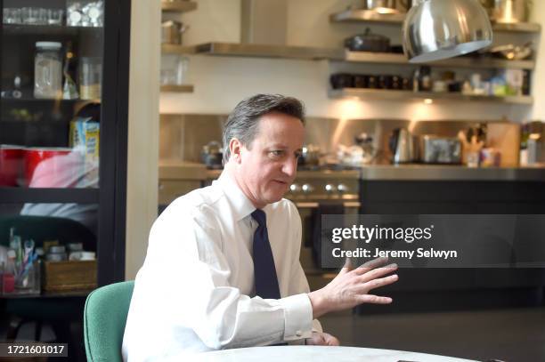 David Cameron In The Downing Street Kitchen..Toothbrushes Inside A Kitchen Cupboard Behind Mr Cameron..David Cameron In His Kitchen In Downing...