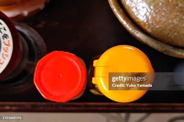 seasoning bottles on kitchen table - lid stock pictures, royalty-free photos & images