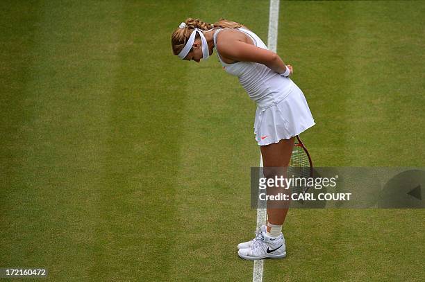 Germany's Sabine Lisicki gives a bow as she celebrates beating Estonia's Kaia Kanepi during their women's singles quarter-final match on day eight of...