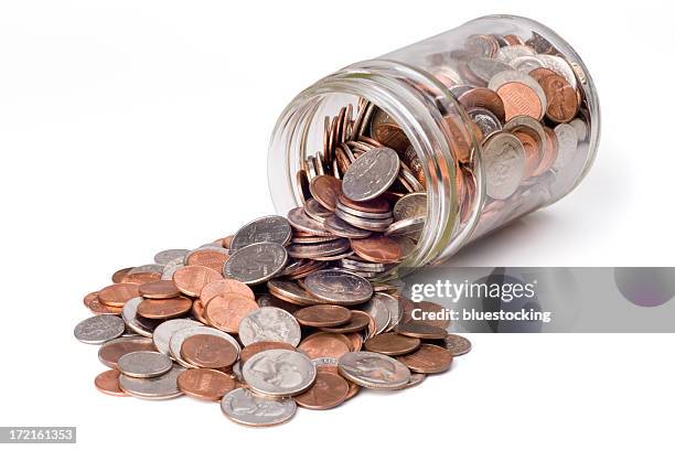 coins spilling from a jar - coin stock pictures, royalty-free photos & images