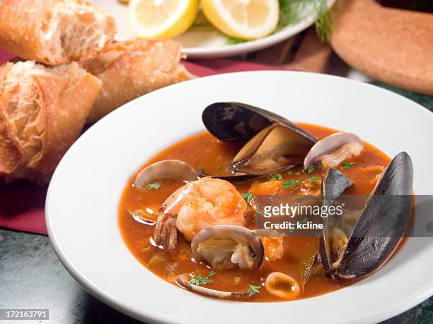 tomato based soup in white bowl - vis en zeevruchten stockfoto's en -beelden
