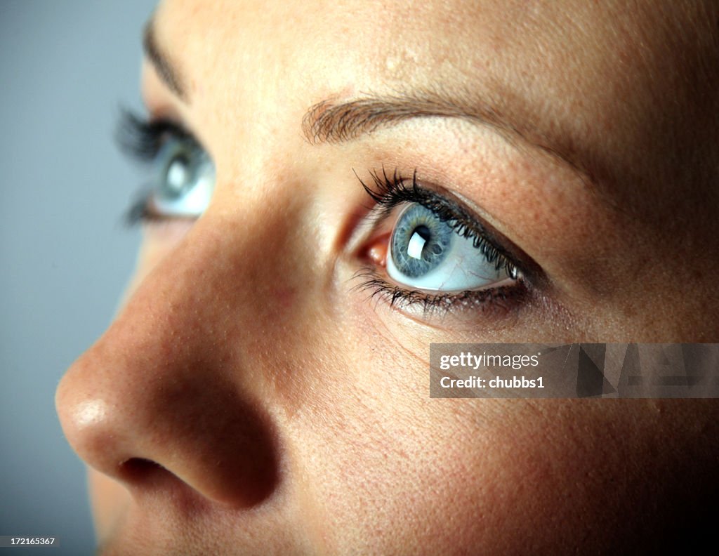 A close up of a young woman's blue eyes