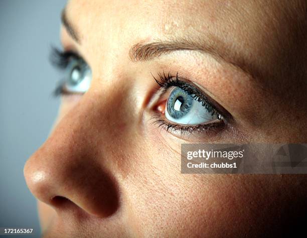 a close up of a young woman's blue eyes - närbild bildbanksfoton och bilder