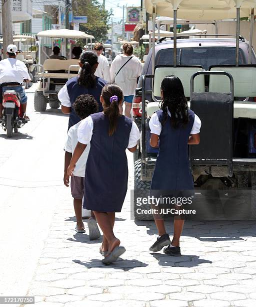 school girls on streets of san pedro - ambergris caye stock pictures, royalty-free photos & images