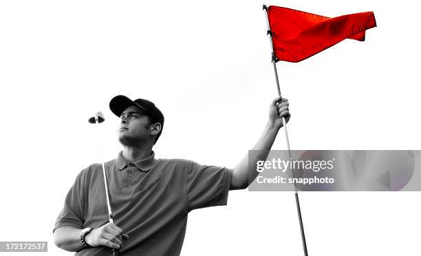 golfer in black and white holding a red flag - red flag warning stock pictures, royalty-free photos & images