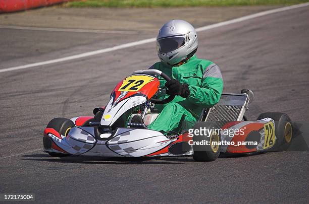 a go kart and driver racing round a track - go cart stock pictures, royalty-free photos & images