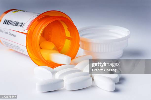prescription pills medicine for healthcare, spilling from labeled medication bottle - prescription drugs dangers stock pictures, royalty-free photos & images