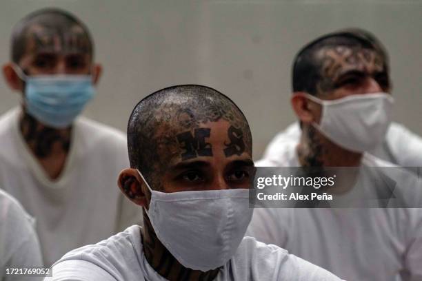 Gang members of the "Mara Salvatrucha" and "Barrio 18" receive religious talk in the interior at CECOT on October 12, 2023 in Tecoluca, El Salvador....