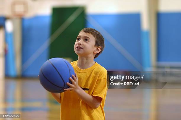 a young child holding a blue basketball - kid studio shot stock pictures, royalty-free photos & images