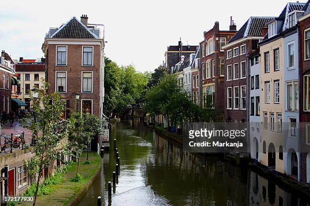 canal running through utrecht on an overcast day - utrecht stock pictures, royalty-free photos & images