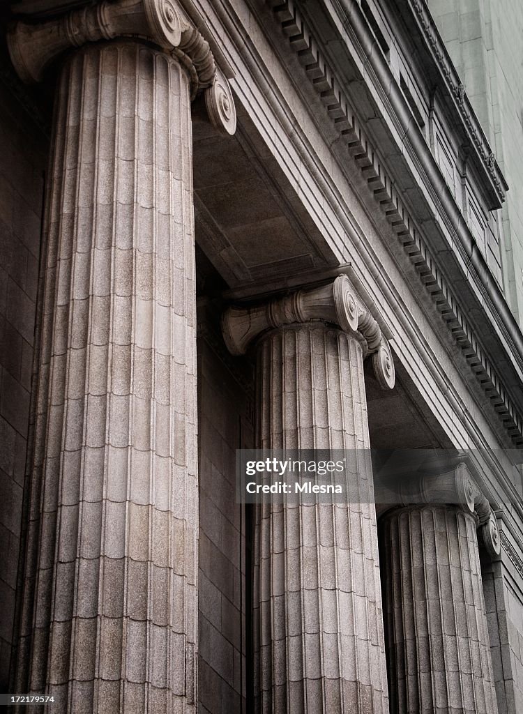 Gray ionic columns at the front of a traditional building