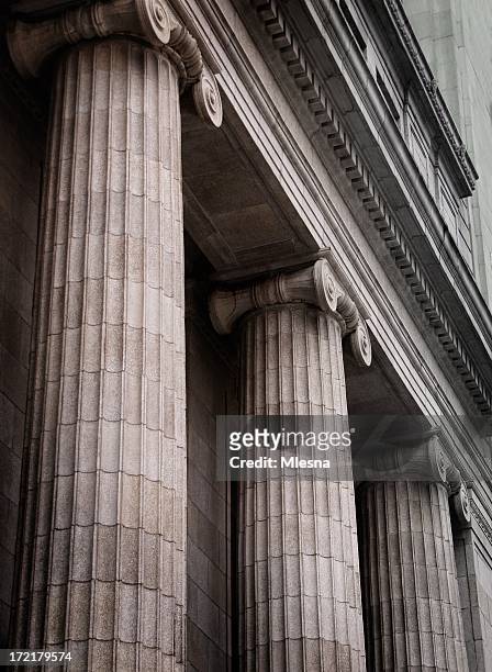 gray ionic columns at the front of a traditional building - justice concept stock pictures, royalty-free photos & images