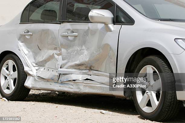 silver car with a large dent in the side, ruining two doors - car accident stock pictures, royalty-free photos & images