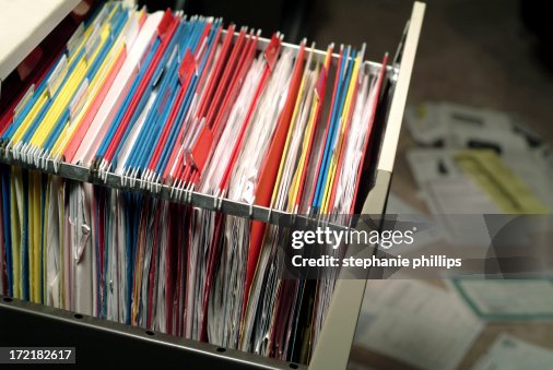 Open File Cabinet with Papers Spread Out on the Floor Open File Cabinet with Papers Spread Out on the Floor