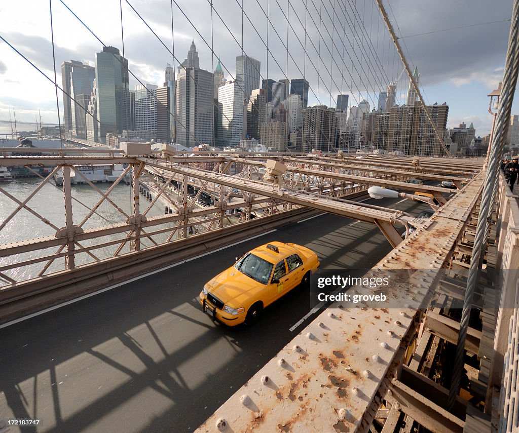 A taxi crossing the Brooklyn Bridge away from the city