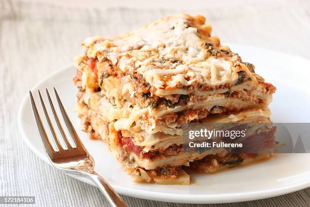 lasagna with fork - serving lasagna stock pictures, royalty-free photos & images