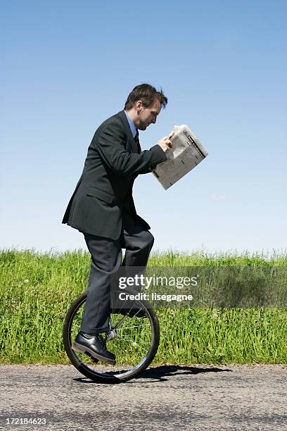 businessman riding unicycle - unicycle stock pictures, royalty-free photos & images