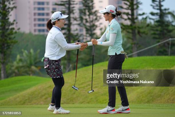 Saipan of Thailand is congratulated by Asuka Ishikawa of Japan after winning the tournament on the 18th green during the play off first hole...