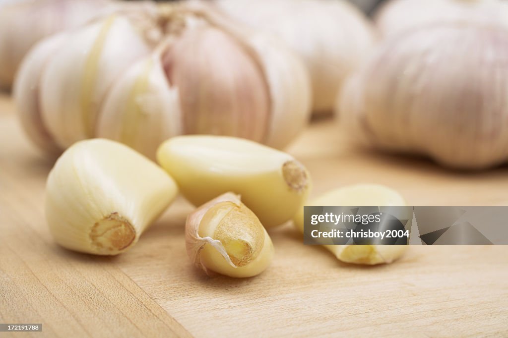 Garlic cloves on a wooden board