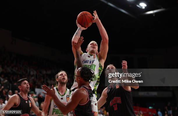 Mitchell Creek of the Phoenix drives to the basket against Todd Blanchfield, Justin Robinson and Sam Froling of the Hawks during the round two NBL...