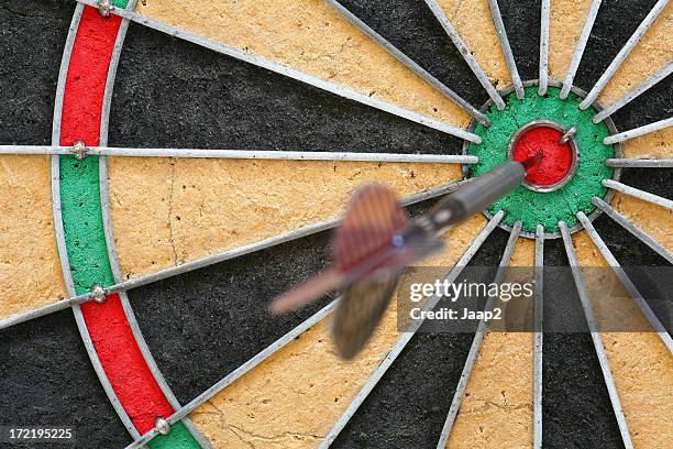 fragment of a dartboard with dart inside the bull's eye - bullseye stock pictures, royalty-free photos & images