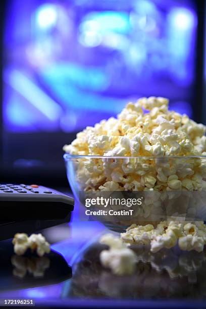 movie night.popcorn remote and television. - late night television bildbanksfoton och bilder