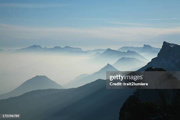 scene of mountain range with a blue tint - grenoble stockfoto's en -beelden
