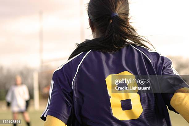 back view of female soccer player in number 8 jersey - collegiate defensive player stock pictures, royalty-free photos & images