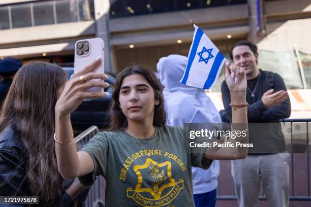 Jewish counter protestor takes a selfie with the Israeli flag near the students from Hunter College during a pro-Palestinian demonstration at the...