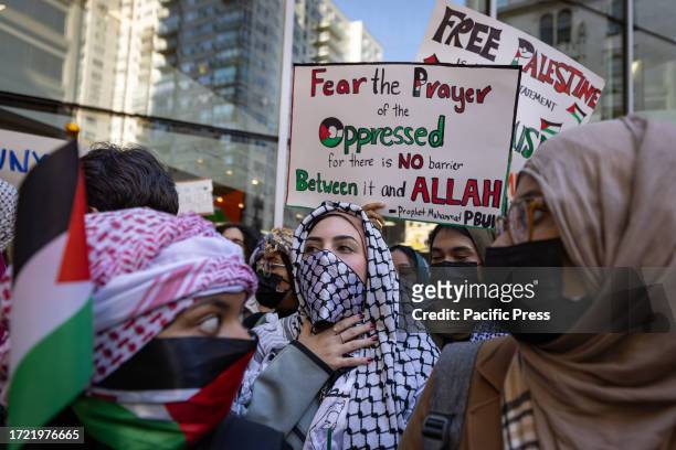 Students from Hunter College chant and hold up signs during a pro-Palestinian demonstration at the entrance of their campus. The pro-Palestinian...